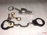 Hand cuffs with key and spur key chain