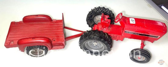 Toys - Ertl brand International Harvester red tractor and Hubley red trailer