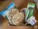 Garden thermometers and rain gauge in packages