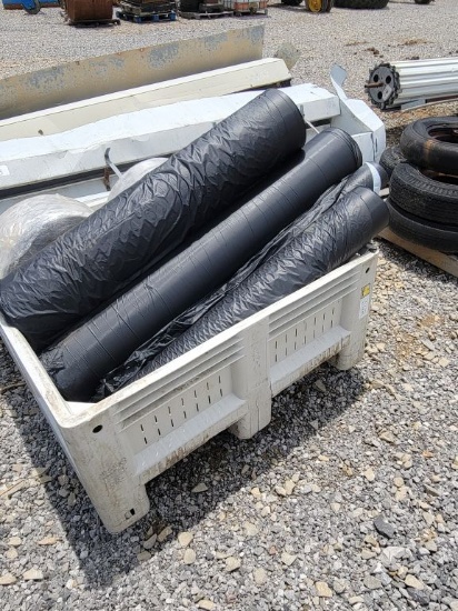 CRATE WITH ROLLS OF PLASTIC