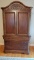 WOODEN ENTERTAINMENT CENTER WITH T.V, DVDS, AND DVD PLAYER
