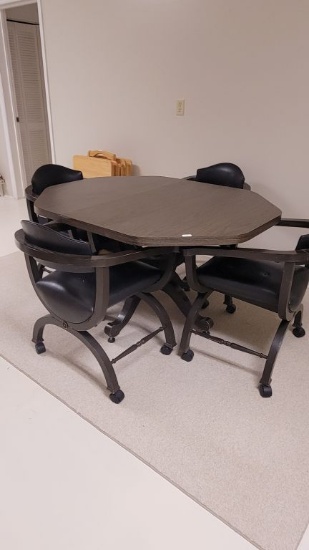 TABLE WITH 4 ROLLING LEATHER CHAIRS, AND LIKE NEW RUG