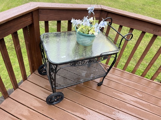 OUTDOOR METAL AND GLASS TABLE ON 2 WHEELS