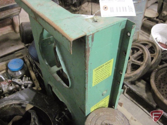 Ladder hoist and pallet of small engines and parts