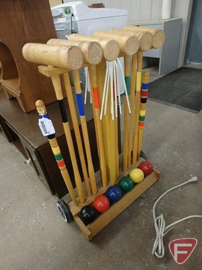 Wood croquet set in rolling stand and Striker Pro dart board, both