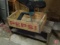 Metal tractor seat, wood Pepsi advertising box, and small wood bench