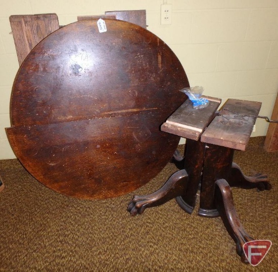 Wood table pedestal with claw feet, wood round table top, and 8 table leaves, not all matching