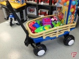 Plastic wagon with plastic toys, buggy, boat, plane, helicopter, trucks, and