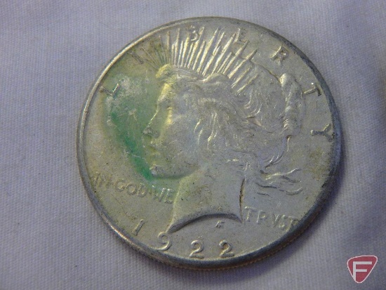 (2) 1922 Peace silver dollars, (1) 1923 Peace silver dollar, all have varying amounts of PVC,