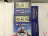 Four notes of colorized 2 dollar bills; State of Delaware, and World Trade Center 