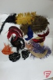 Assortment of decorative feathers and masquerade masks, in tote with cover