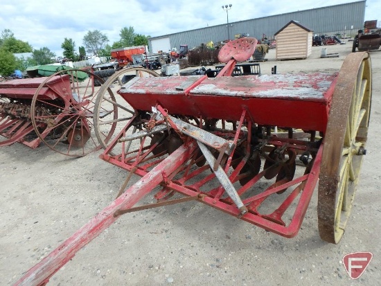 Van Brunt approx. 7 ft. pull-behind grain drill with two spare wheels