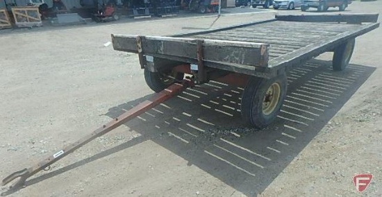 Case running gear with implement tires, with wood hay rack, 8.5 ft. x 16.5 ft.