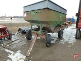 Green gravity box with tank extension on orange running gear with flotation tires