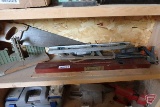 Contents of shelf, Levels, clamps, caulking gun, saws, miter box