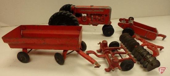 Vintage metal red toy tractor with wagon, and disk no. 9827, manure spreader