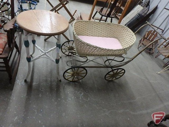 Vintage metal buggy frame, one wheel does not match, with wicker bassinet/basket and