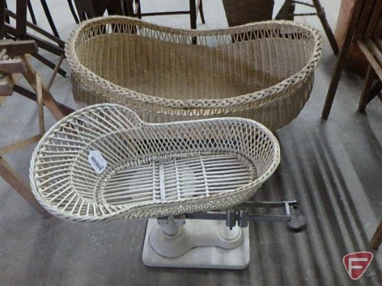 Vintage wicker bassinet on wood frame and vintage baby sliding weight scale with wicker basket, Both