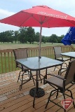 Patio table with glass top, (2) swivel chairs, red umbrella with Budweiser beer advertising,