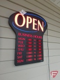 Lighted 'Open Business Hour' sign, lists hours Monday through Friday