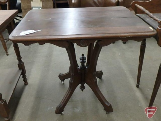 Wood occasional table with pedestal, on wheels, 28inHx30inWx21D