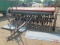 10' McCormick grain drill with grass seed box, double disc, manual lift, wooden spoke wheels