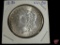 1886 Morgan Silver Dollar uncirculated, heavy half-moon toning on reverse