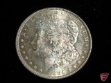 1884 Morgan Silver Dollar uncirculated, heavy toning on obverse and revers