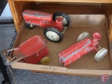 Vintage red toys; tractors, disc, wagons, metal toy cart and cabinet