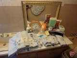 All in bathroom corner: matching blue towels and rugs, clothes hampers, curlers, mirror,
