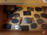 Contents of drawer: belt buckles and pocket knives, Farm Fest, Browning, Remington, Alaska