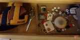 Contents of drawer: scissors, women's rings, some Avon, some turquoise, earrings, wood