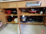 Contents of two cupboards: pots and pans, wok, toaster, tea pot, and