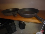 (2) cast iron fry pans, one marked John Deere on bottom, other made in Korea