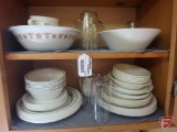 Contents of cupboard: Corelle dishware, not all matching, glasses, cups, bowl