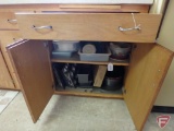 Contents of drawer and cupboard: flatware, kitchen utensils, can opener, metal bakeware,