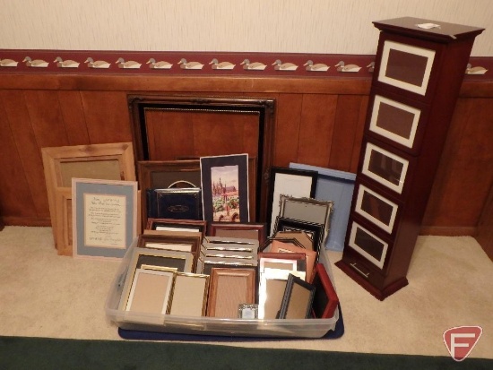 Assortment of picture frames, some prints, wood photo storage tower. All frames/photo items