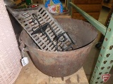 Cast iron kettle with large crack on side, fireplace grate and metal shelf