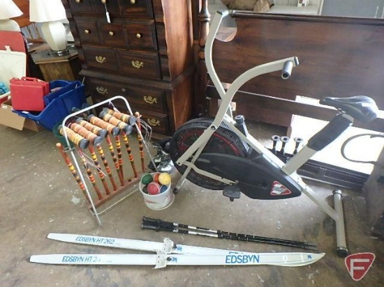 Wood croquet set in stand with ceramic balls, Air Bike 950 exercise bike, and