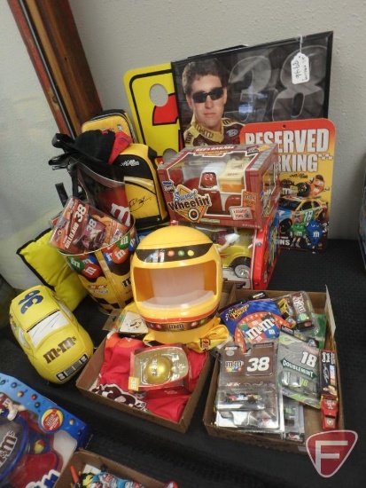 M&M items, NASCAR, toy cars, soft side cooler, water jug, metal trash can, dispensers,