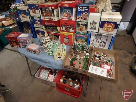 Metal folding table with Holiday items: lighted village pieces with accessories, and ornaments.