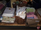 Towels, table linens, some vintage, table coverings. Contents of box and 2 baskets.