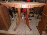 Wood ornate occasional table on wheels, one leg needs repair, 30inHx28inx22in