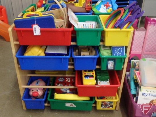 Plastic bins in wood shelf, Twister, magnets, wood blocks, Phonics Bus, Tonka garbage truck,