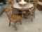 Wood 47in round table with (4) leaves, and (6) matching chairs.