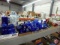 Blue, red, and green glass items, vases, bottles, bowls, candle holders, candy dishes, jars.