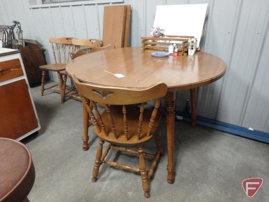 Wood 47in round table with (4) 11.5in leaves and (4) wood chairs. Items on top of table are NOT
