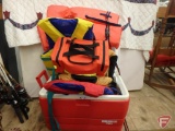 Igloo chest cooler, flotation vests, boater emergency kit, fishing rods with reels, and buoys.