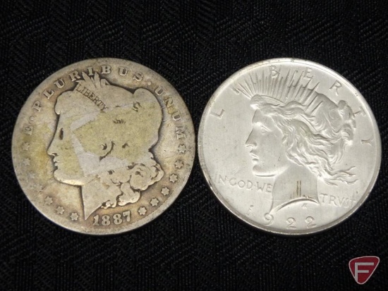 1887 O Morgan silver dollar, good, and 1922 Peace dollar, AU. 2 coins