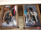 Two drawers of kitchen utensils, two cupboards of cookie sheets, pots and pans, casseroles